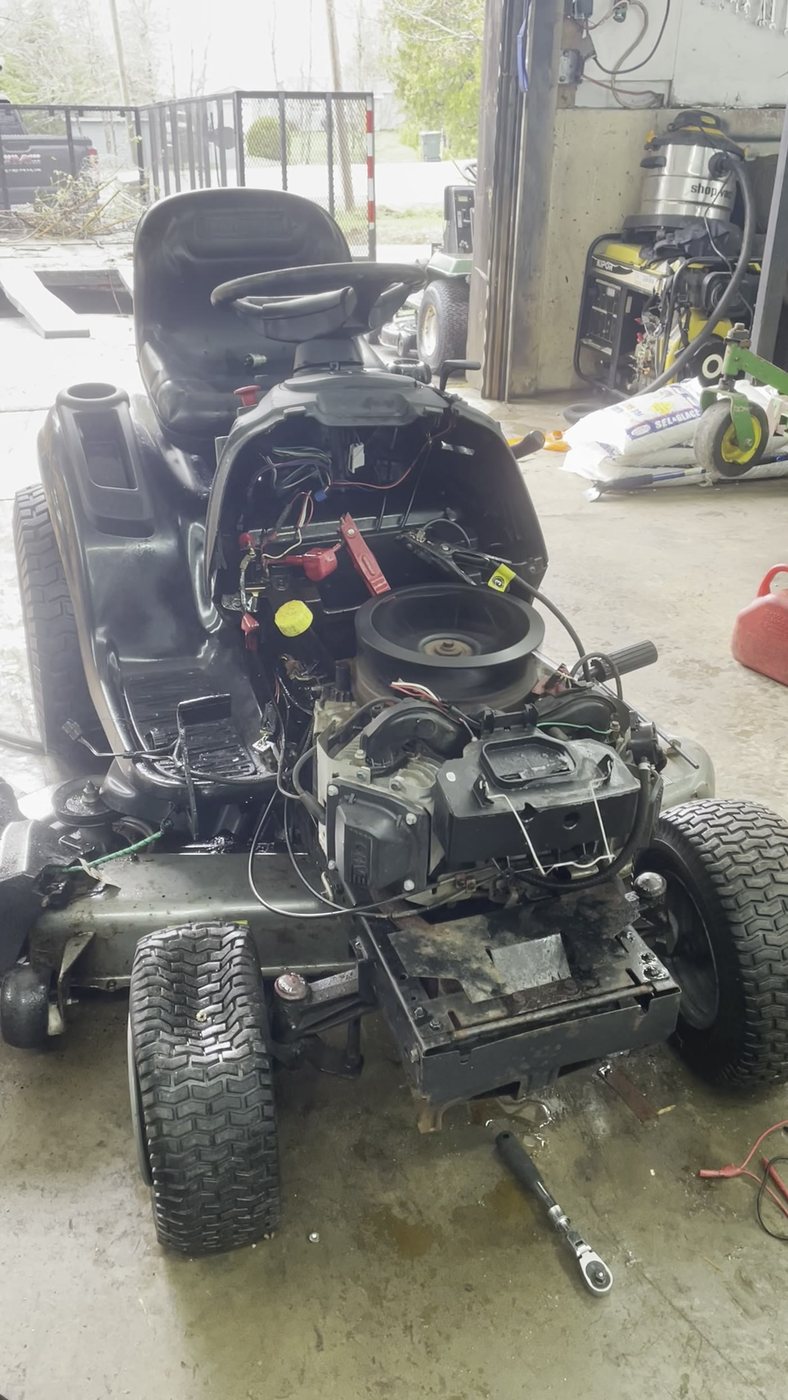 Riding mower undergoing service in the Fundy Small Engine Repair workshop